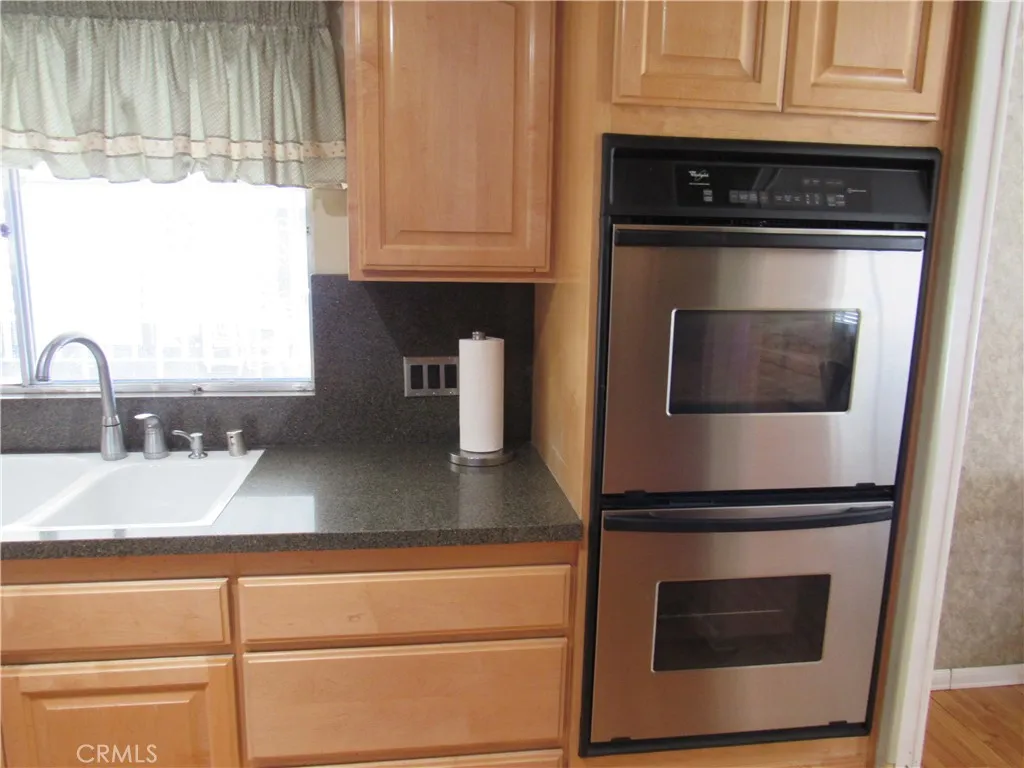 27701 Murrieta Road, Unit 6 Menifee, CA 92586 - Photo 14 of 28 a kitchen with granite countertop a stove and a microwave