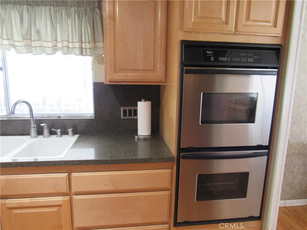 27701 Murrieta Road, Unit 6 Menifee, CA 92586 - Photo 14 of 28 a kitchen with granite countertop a stove and a microwave