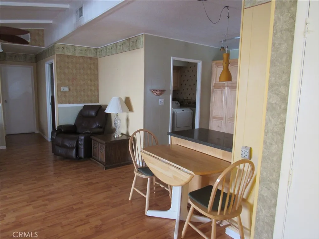 27701 Murrieta Road, Unit 6 Menifee, CA 92586 - Photo 9 of 28 a view of a dining room with furniture and wooden floor