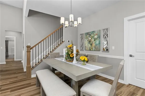 a view of a dining room with furniture and chandelier
