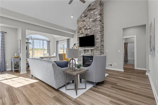 a living room with furniture a fireplace and a flat screen tv
