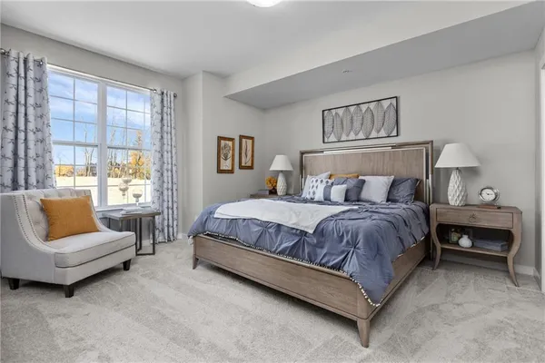 a spacious bedroom with a bed and a couch