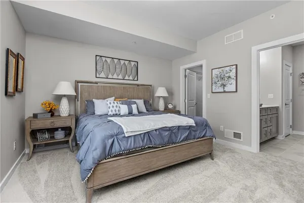 a bedroom with a bed and a chandelier