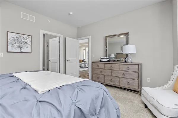 a bedroom with a bed and a dresser