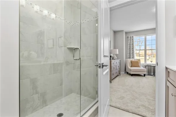 a en suite bathroom with a tub shower and bedroom