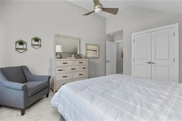 a spacious bedroom with a bed and a couch