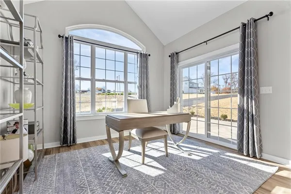 a view of a workspace with furniture and a window