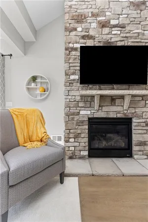 a living room with a fireplace and a flat screen tv