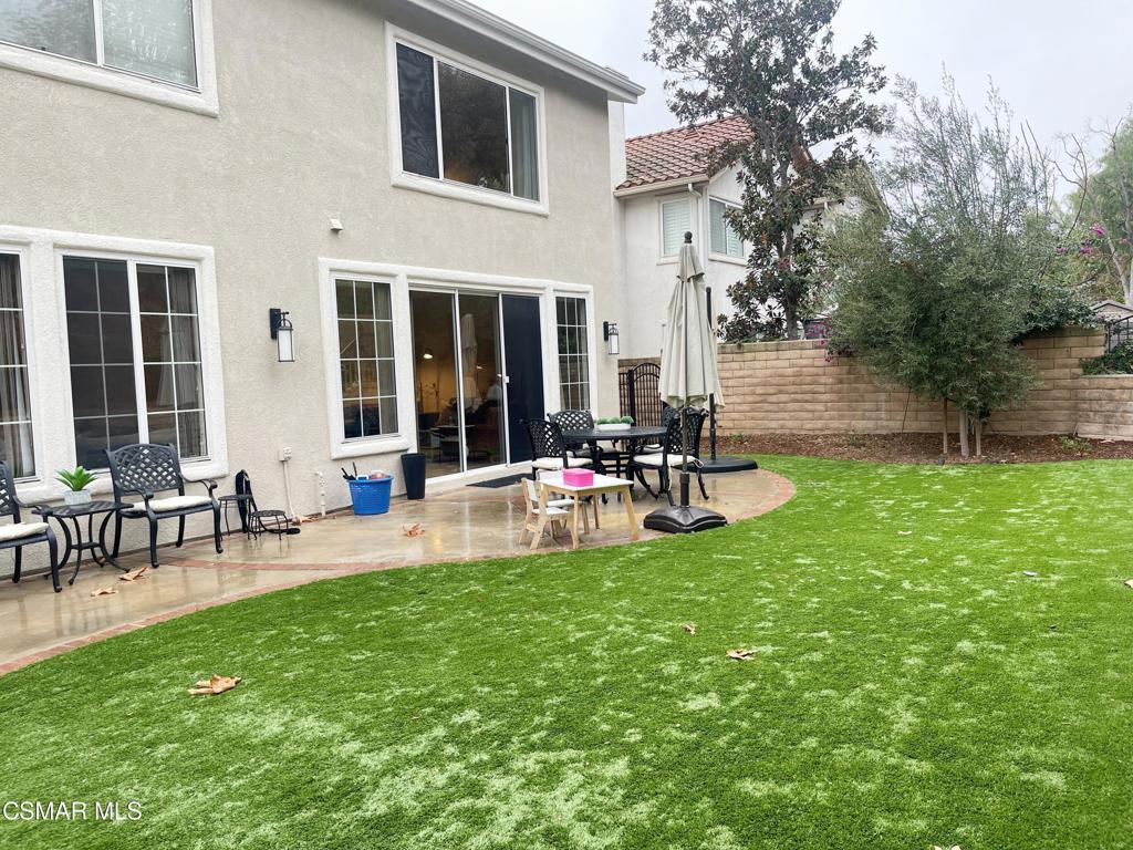 2437 Whitechapel Place Thousand Oaks, CA 91362 - Photo 35 of 36 a view of a patio with table and chairs and garden