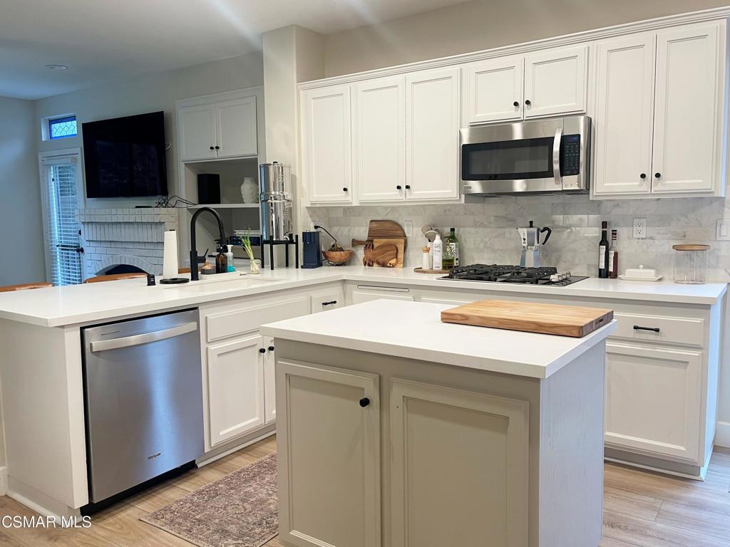 2437 Whitechapel Place Thousand Oaks, CA 91362 - Photo 8 of 36 a kitchen with stainless steel appliances a stove microwave and sink