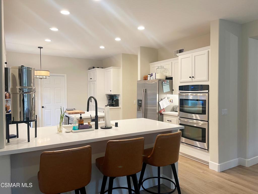 2437 Whitechapel Place Thousand Oaks, CA 91362 - Photo 10 of 36 a kitchen with stainless steel appliances granite countertop a stove and a refrigerator