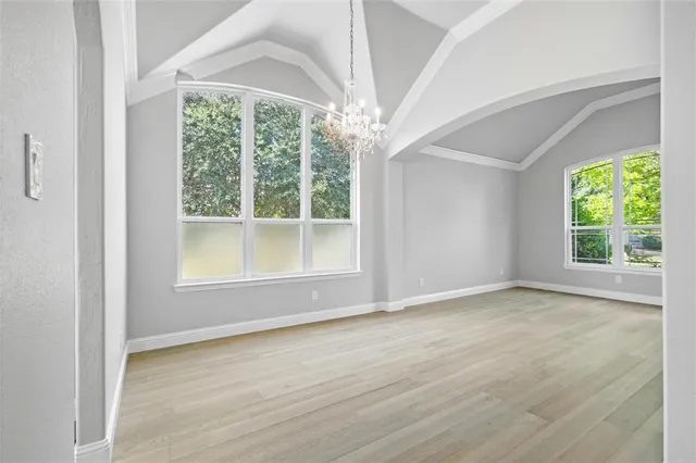 a spacious bedroom with a bed and a window