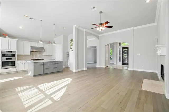 a view of a big room with wooden floor and a bathroom
