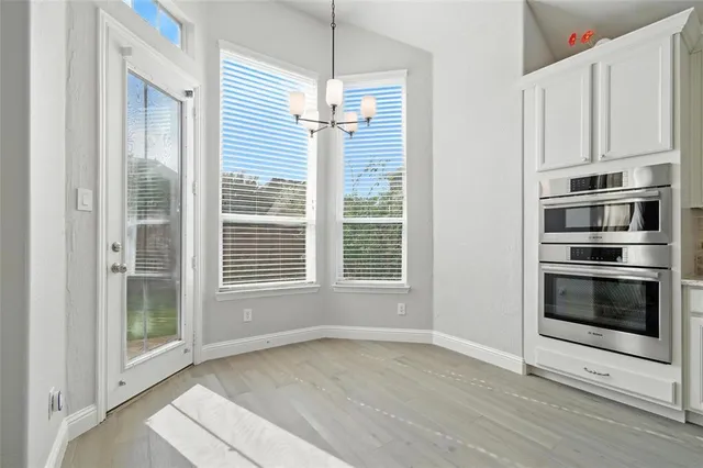 a living room with stainless steel appliances kitchen island furniture and wooden floor