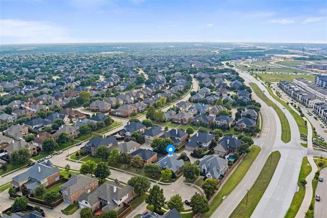 an aerial view of a house with garden space and lake view