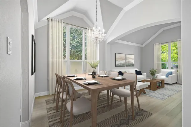 a dining room with furniture a chandelier and wooden floor