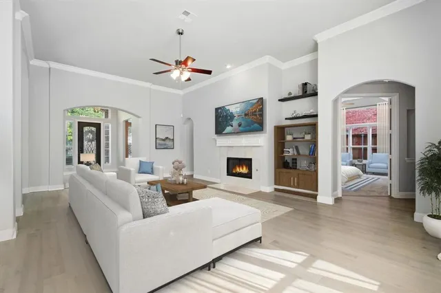 a living room with furniture a fireplace and a flat screen tv