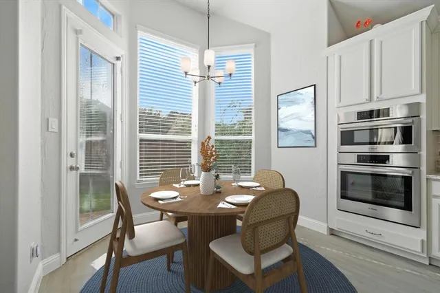 a kitchen with a sink stove and wooden floor