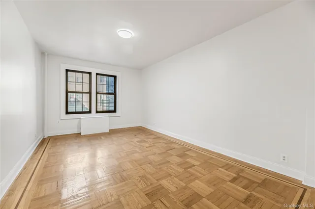 a view of a hallway with wooden floor and entryway