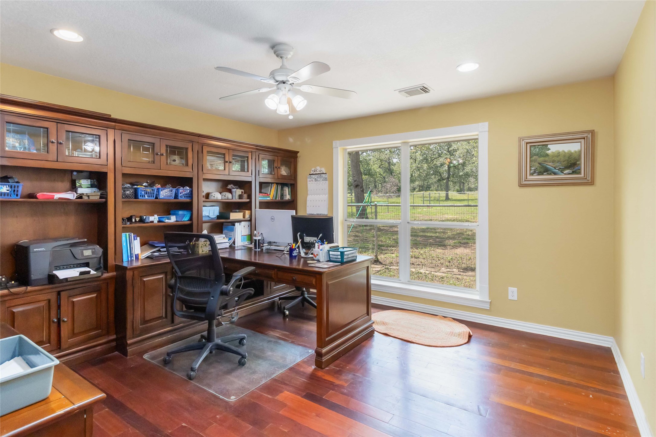 1208 Jeddo Road Rosanky, TX 78953 - Photo 23 of 40 Custom built-in cabinetry and ample lighting elevate this well-appointed home office.