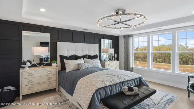 a bedroom with a large bed and a chandelier