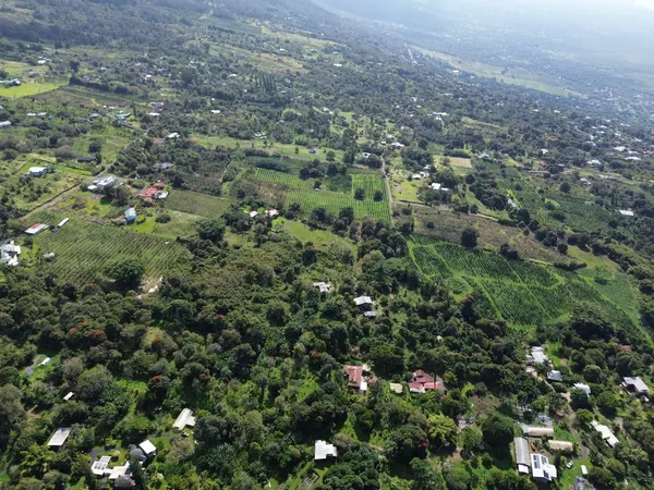 an aerial view of a house with a yard