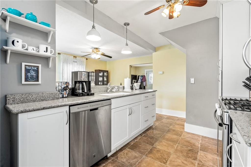 416 Maple Avenue Pittsburgh, PA 15215 - Photo 14 of 38 a kitchen with stainless steel appliances granite countertop a sink and a refrigerator