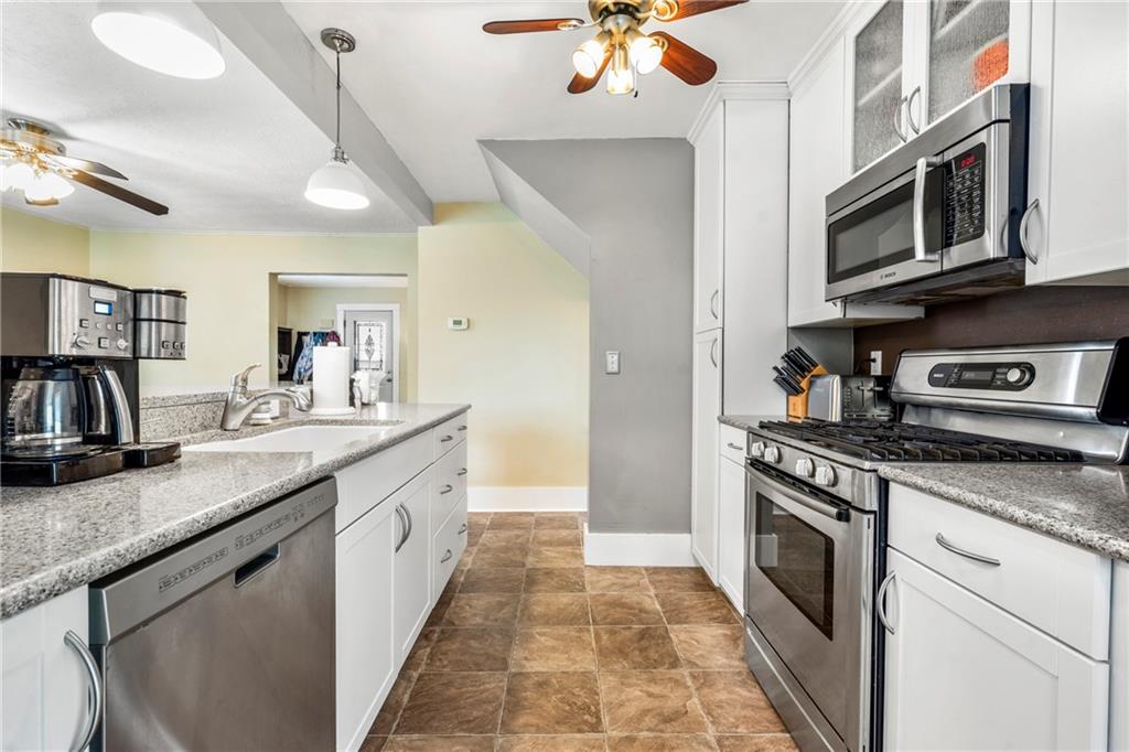 416 Maple Avenue Pittsburgh, PA 15215 - Photo 15 of 38 a large kitchen with stainless steel appliances granite countertop a stove and a sink
