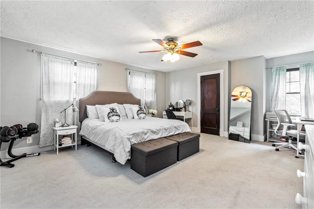 416 Maple Avenue Pittsburgh, PA 15215 - Photo 17 of 38 a spacious bedroom with a bed garage and window