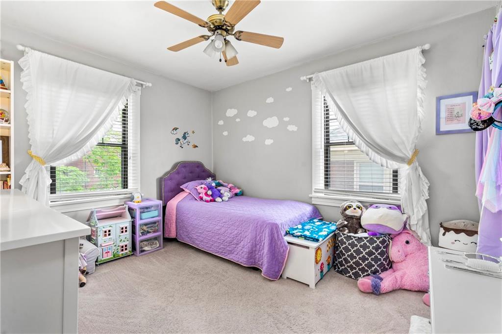 416 Maple Avenue Pittsburgh, PA 15215 - Photo 22 of 38 a bedroom with a bed and a chandelier