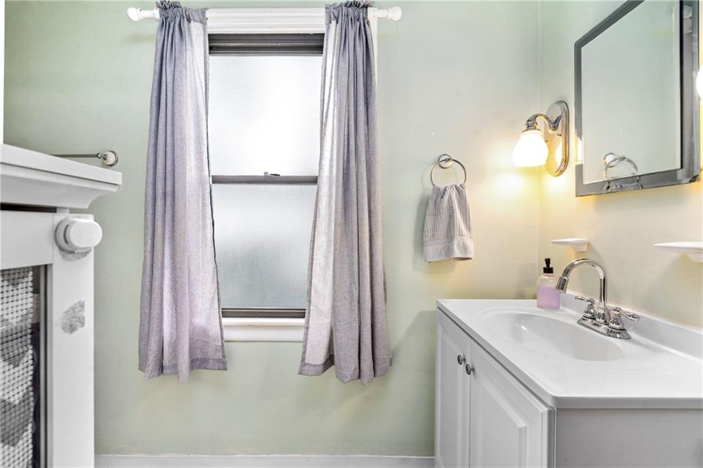 416 Maple Avenue Pittsburgh, PA 15215 - Photo 24 of 38 a bathroom with a sink vanity and mirror
