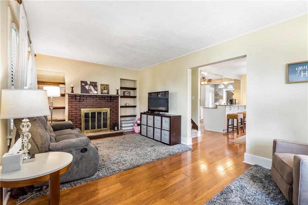 416 Maple Avenue Pittsburgh, PA 15215 - Photo 5 of 38 a living room with furniture a flat screen tv and a fireplace