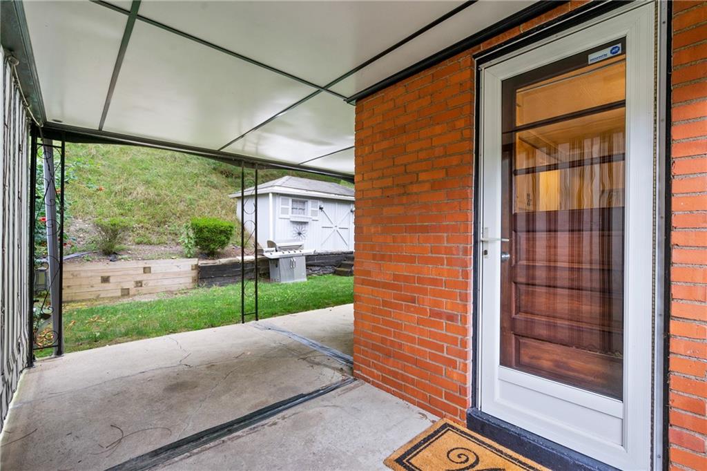459 Filmore Road Pittsburgh, PA 15221 - Photo 18 of 23 a view of a porch with a floor to ceiling window and wooden floor