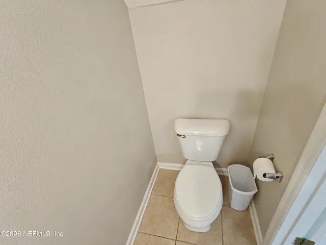 a view of a house with a wooden fence