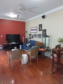 841 Northwest 82nd Lane Boca Raton, FL 33487 - Photo 5 of 9 a living room with furniture a flat screen tv and kitchen view
