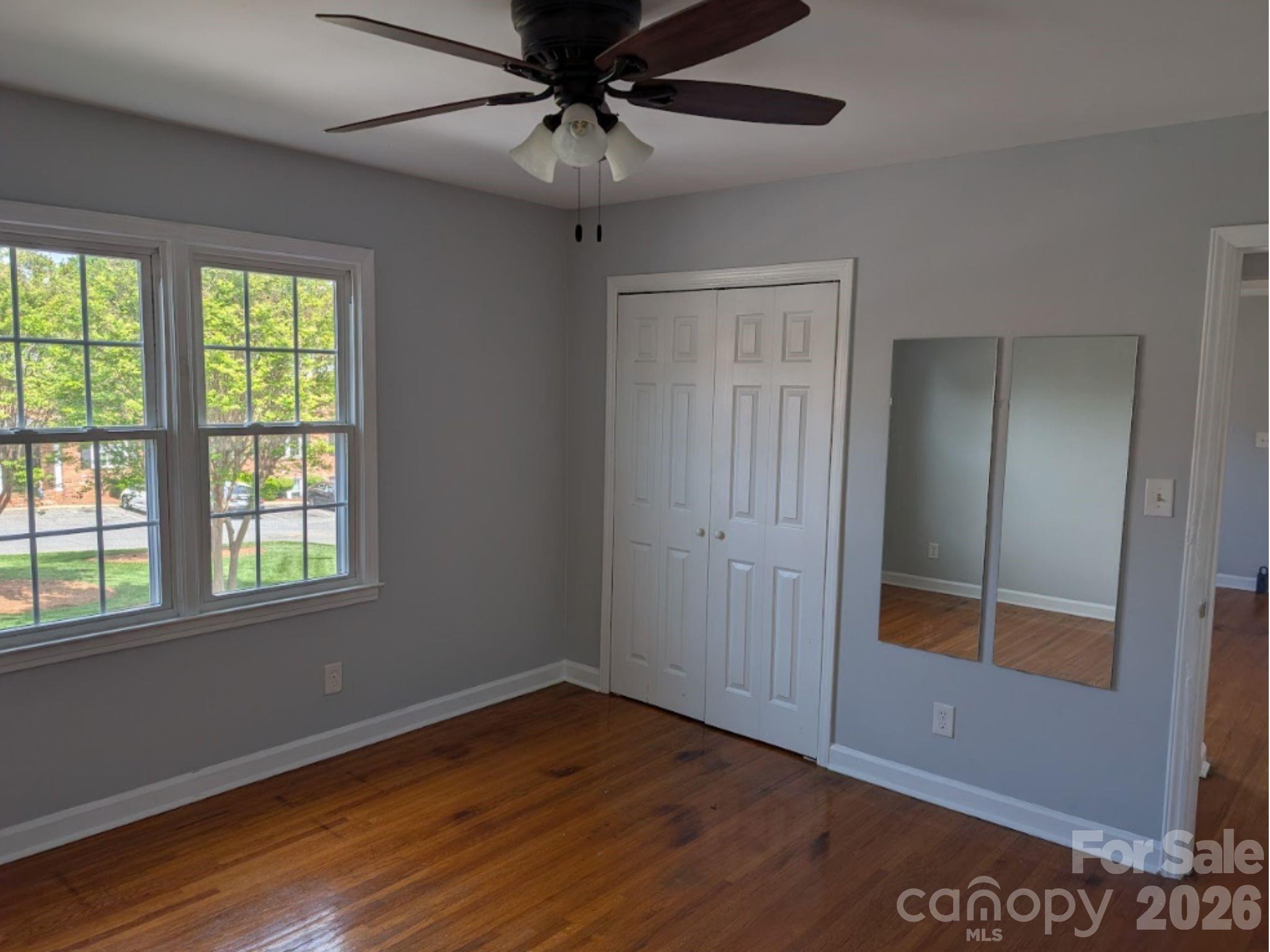 910 McAlway Road, Unit C Charlotte, NC 28211 - Photo 9 of 13 a view of an empty room with wooden floor and a window