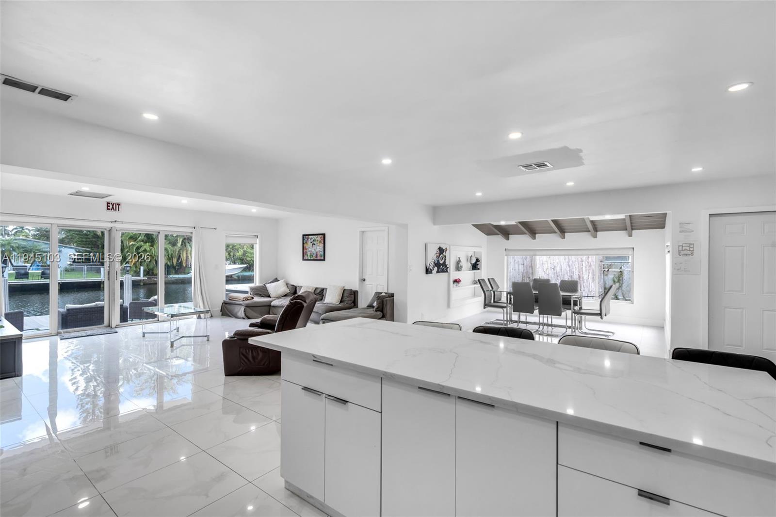 2721 Harding Street Hollywood, FL 33020 - Photo 14 of 38 a kitchen with counter top space and living room view