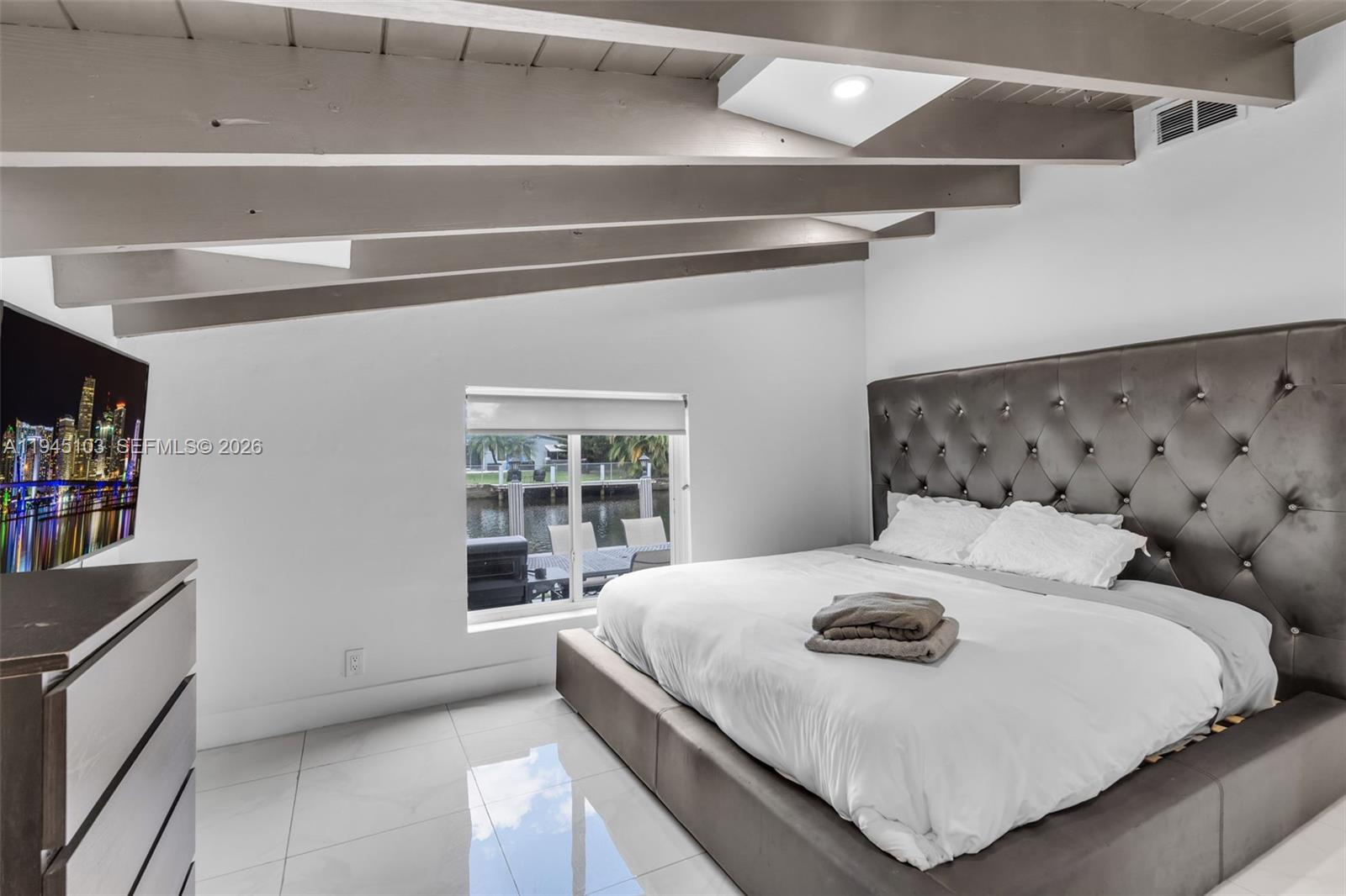 2721 Harding Street Hollywood, FL 33020 - Photo 18 of 38 a bedroom with a bed and window