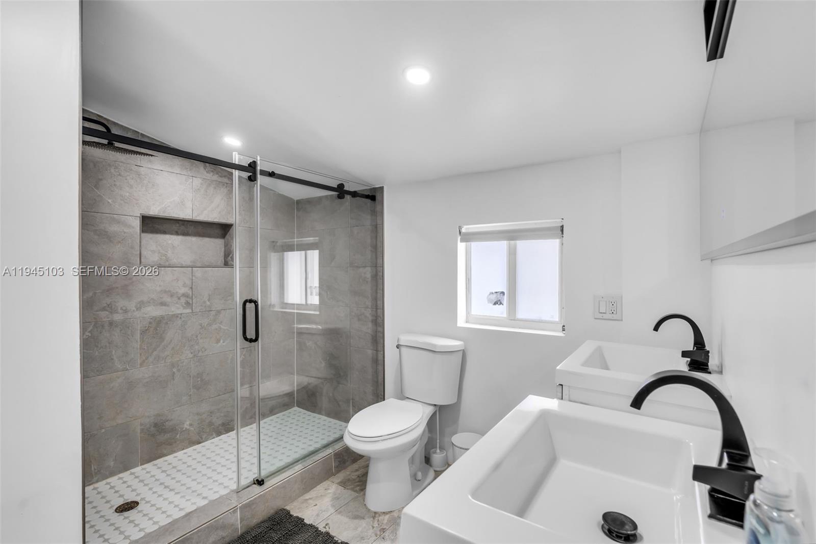 2721 Harding Street Hollywood, FL 33020 - Photo 19 of 38 a bathroom with a sink toilet and shower