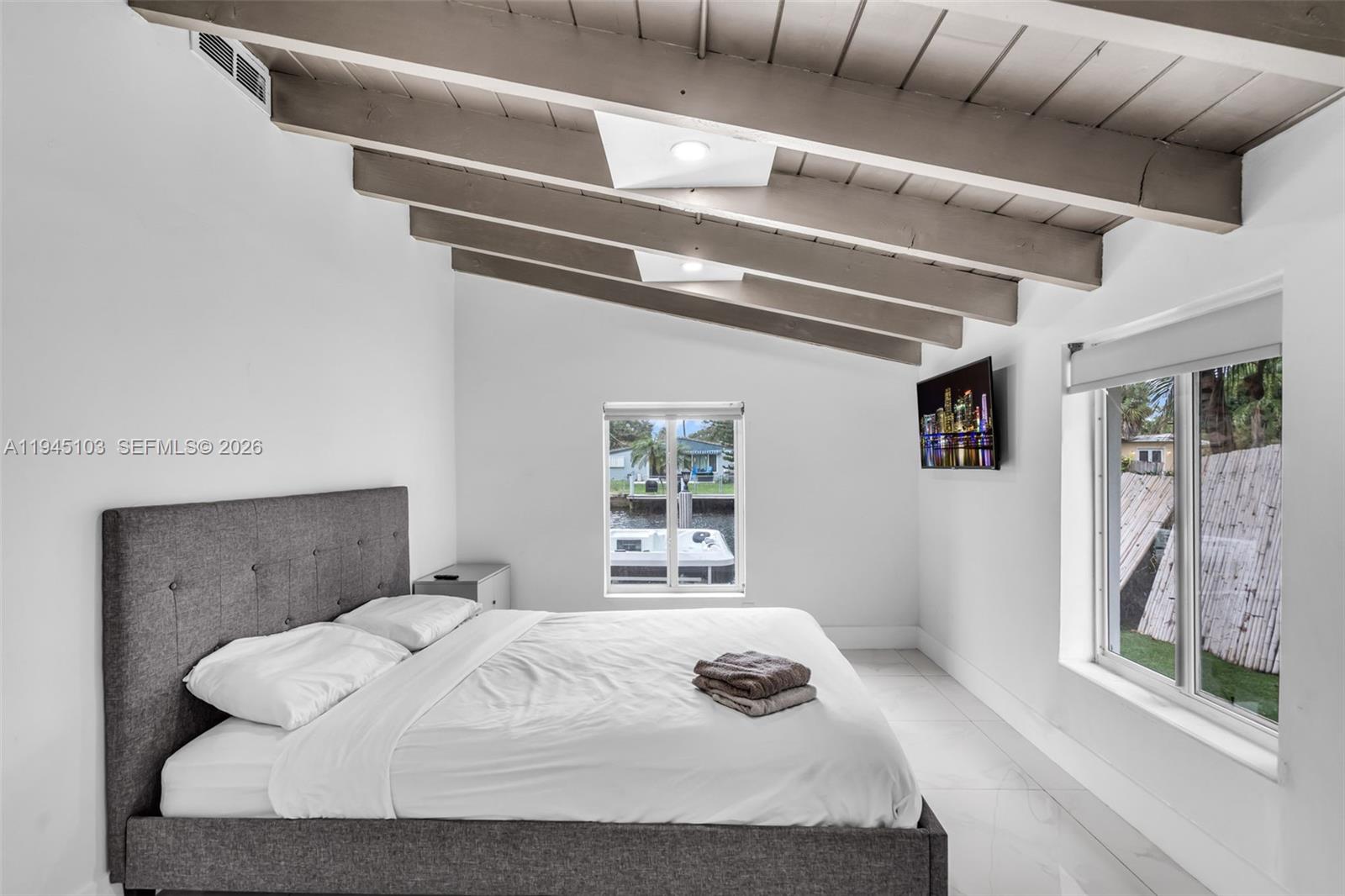 2721 Harding Street Hollywood, FL 33020 - Photo 22 of 38 a bedroom with a bed and window