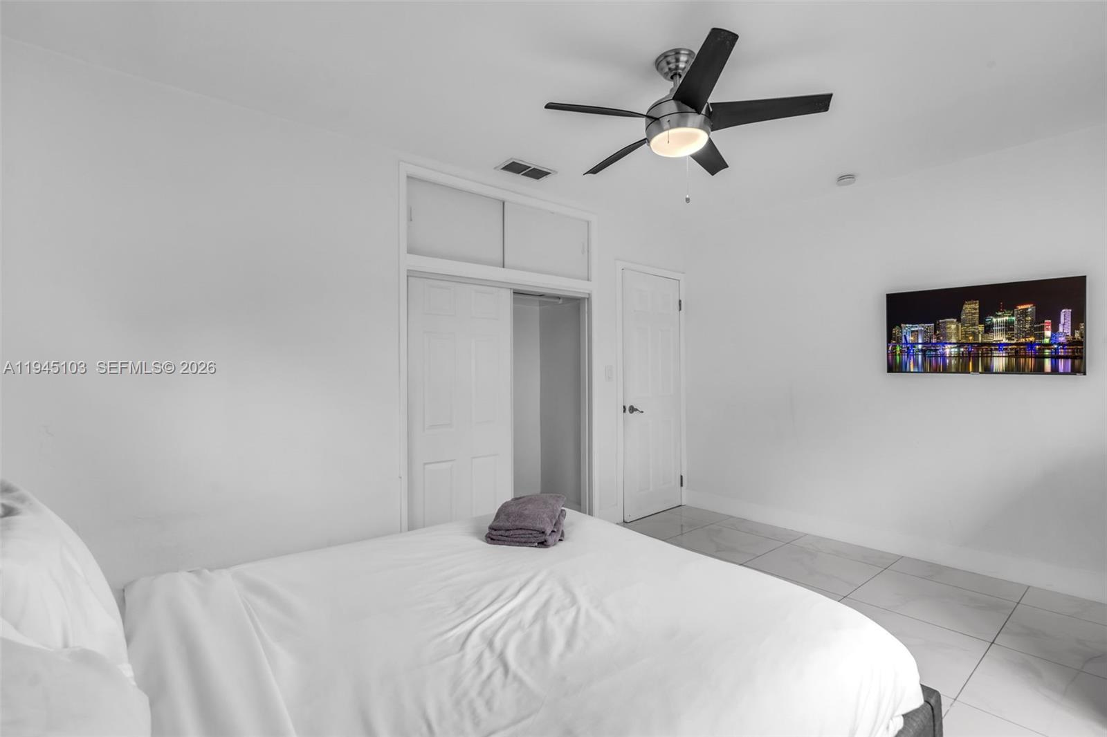 2721 Harding Street Hollywood, FL 33020 - Photo 24 of 38 a bedroom with a bed and a chandelier