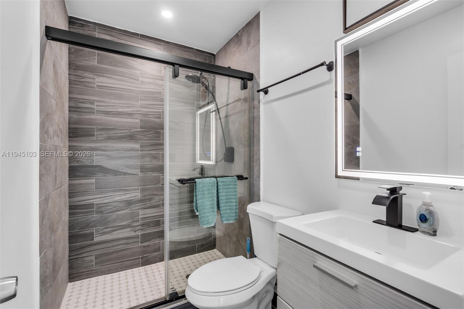 2721 Harding Street Hollywood, FL 33020 - Photo 27 of 38 a bathroom with a sink toilet and shower