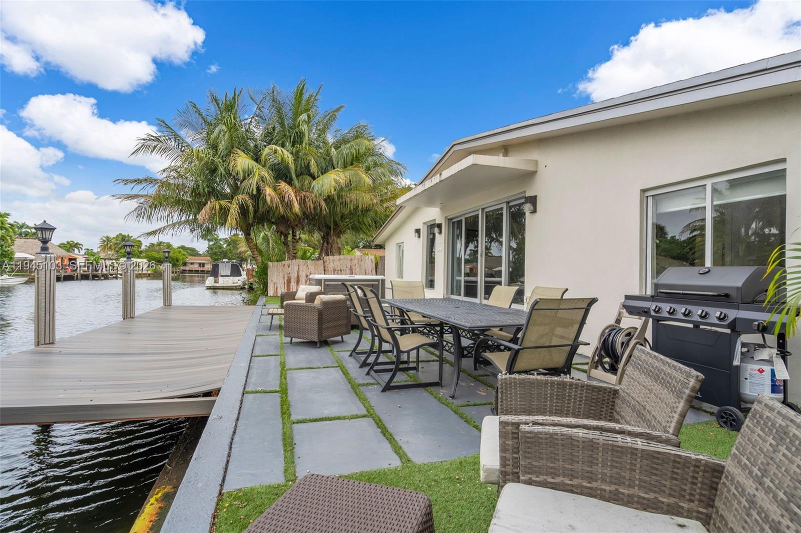 2721 Harding Street Hollywood, FL 33020 - Photo 31 of 38 a view of a patio with couches and a potted plant on the floor