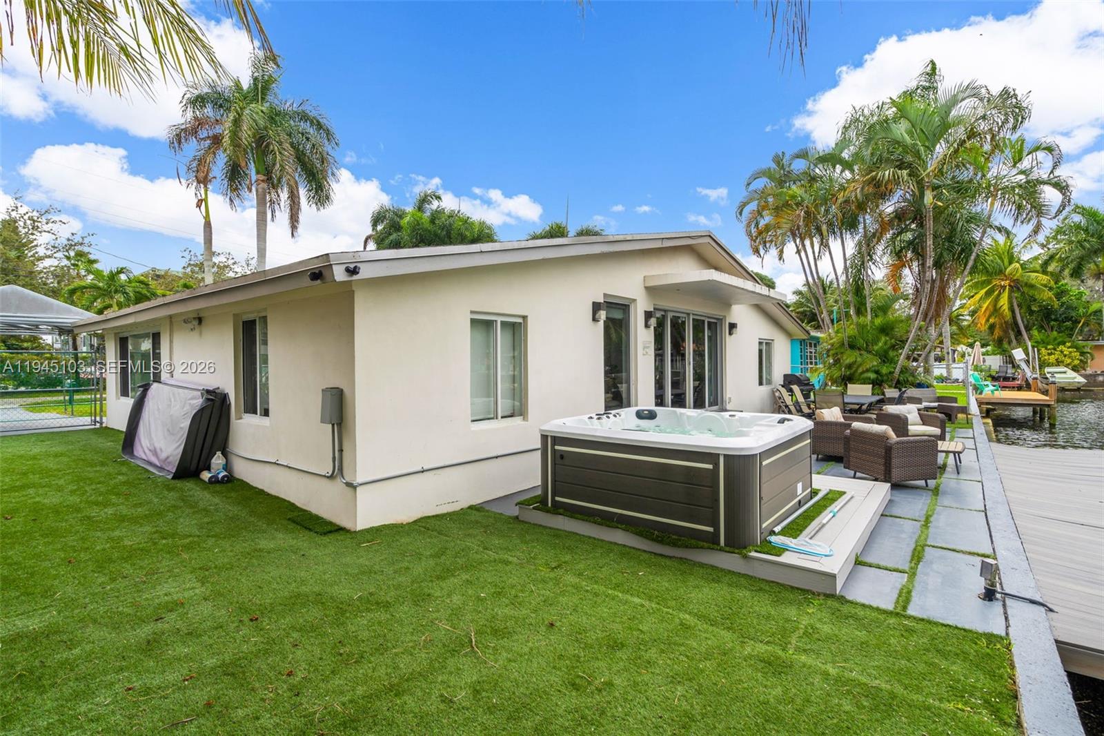 2721 Harding Street Hollywood, FL 33020 - Photo 6 of 38 a view of a white house with a big yard and large trees