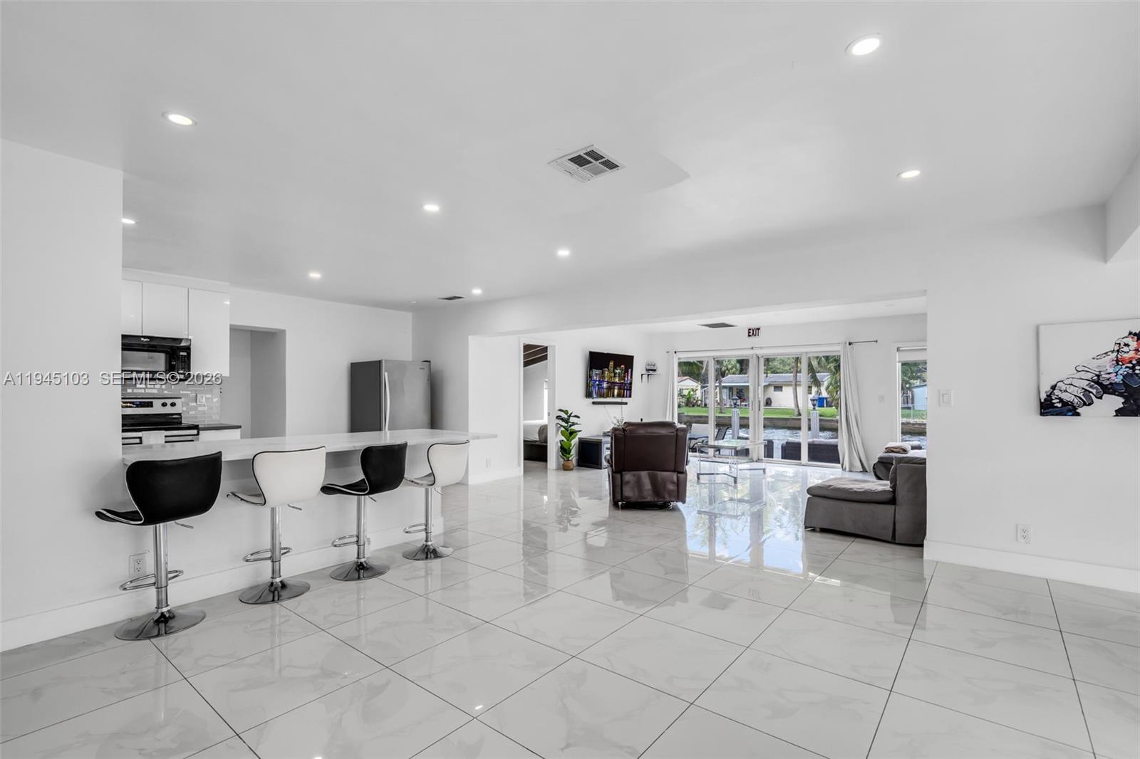 2721 Harding Street Hollywood, FL 33020 - Photo 8 of 38 a living room with furniture and white walls