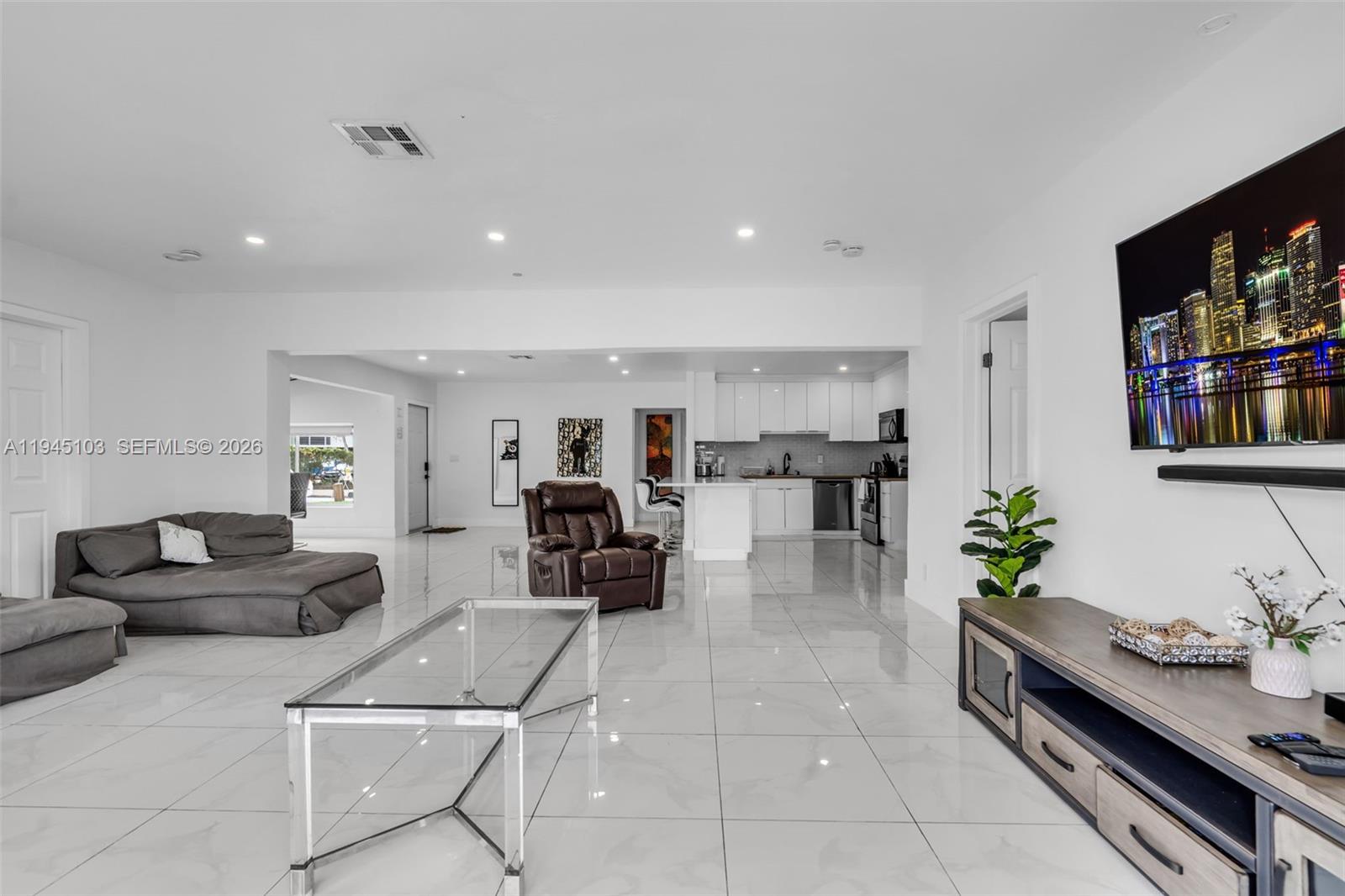 2721 Harding Street Hollywood, FL 33020 - Photo 10 of 38 a living room with furniture and a flat screen tv