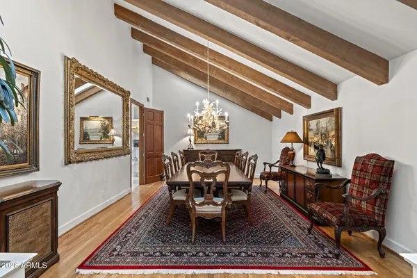 a room with wooden floor pool table and windows