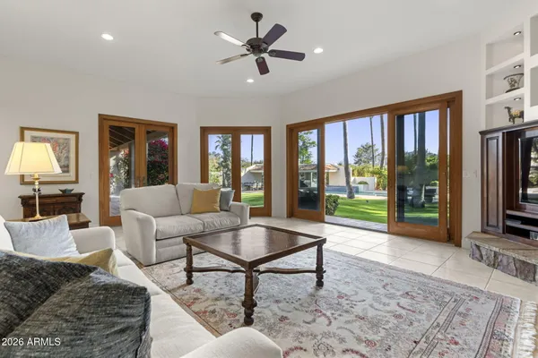 a spacious bedroom with a bed and a flat tv screen