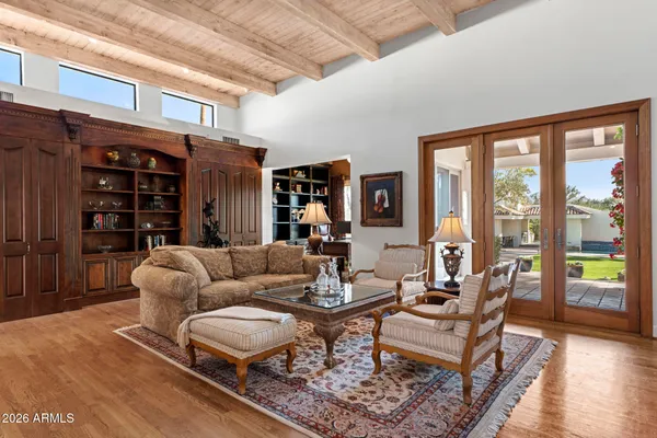 a dining room with furniture water view and a floor to ceiling window