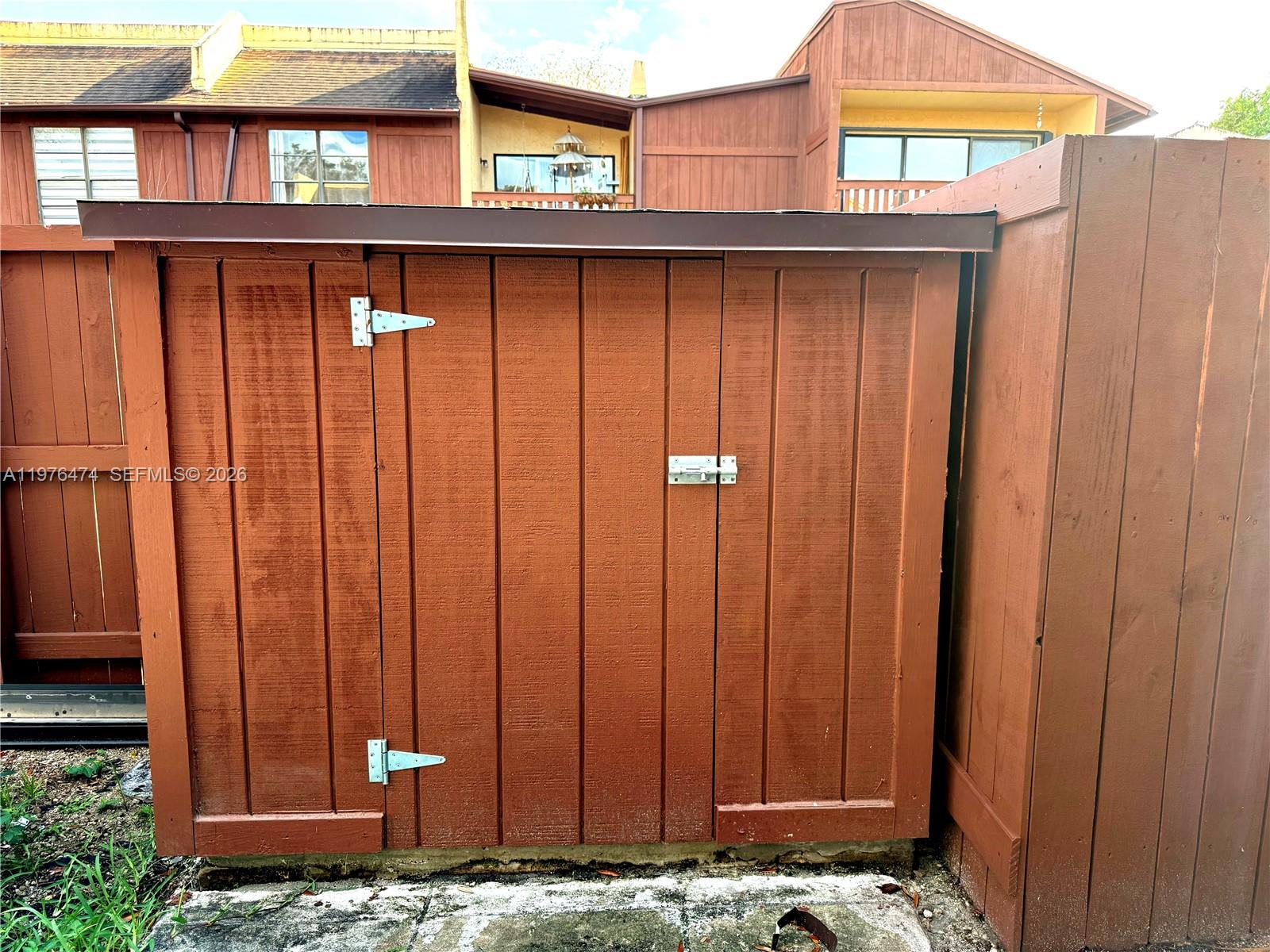 6977 Southwest 115th Place, Unit E33 Miami, FL 33173 - Photo 31 of 32 Rear Storage Shed View